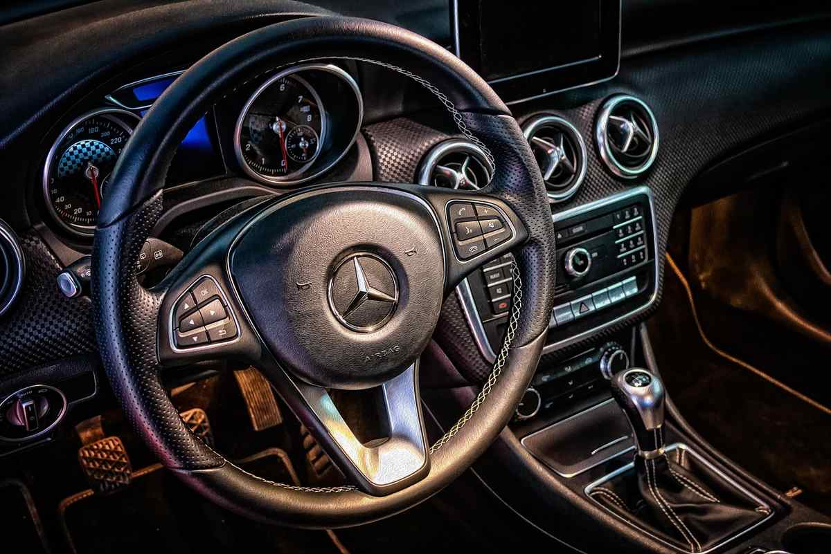 Intérieur sombre du véhicule, volant sport, compteurs éclairés, console centrale